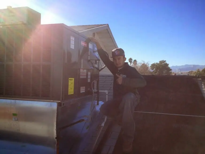 HVAC technician performing Air Duct Cleaning on a rooftop unit in South Union